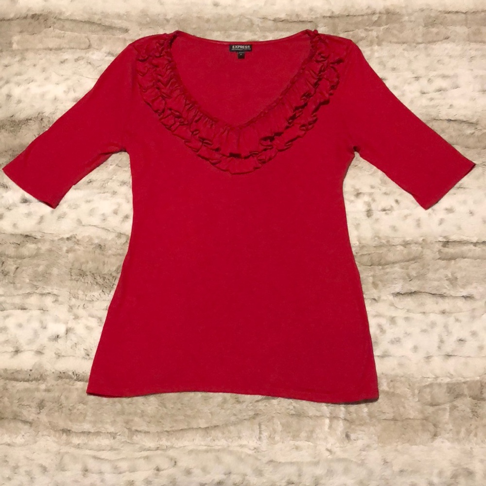 Red top with ruffles around neckline.